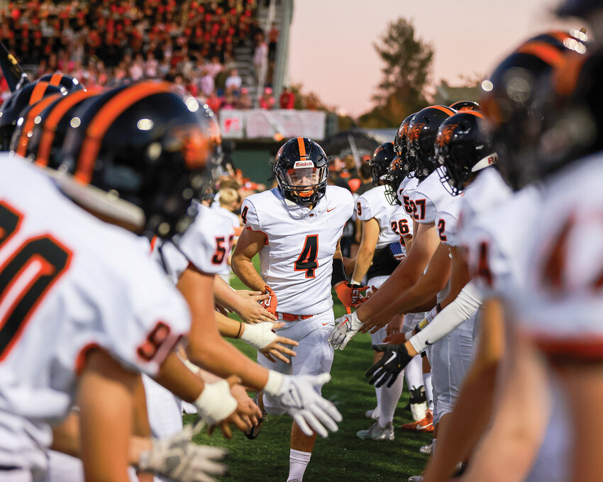 Battle Ground Tigers running back and linebacker Jacob Champine runs through the tunnel of players prior to a football game in the fall season. Champine signed his letter of intent to continue his football career at George Fox University in Newberg, Oregon.