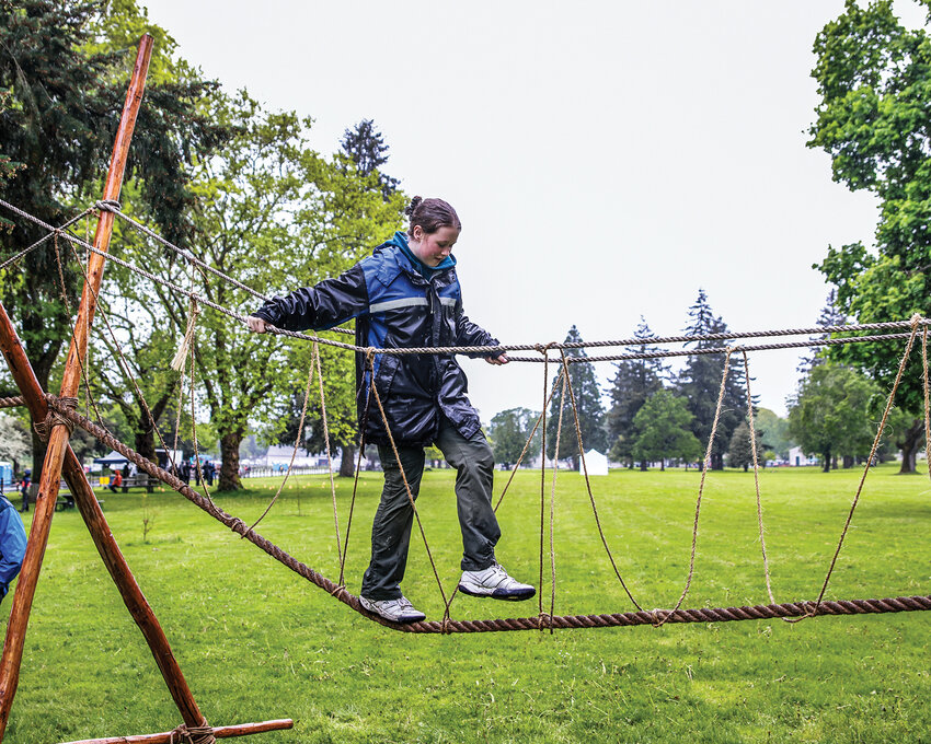 Sophia McCarthy from Troop 351 in southeast Portland takes on the rope bridge during a Boy Scout’s Oregon Trail Camporee at the Fort Vancouver National Historic Site from May 3-5.