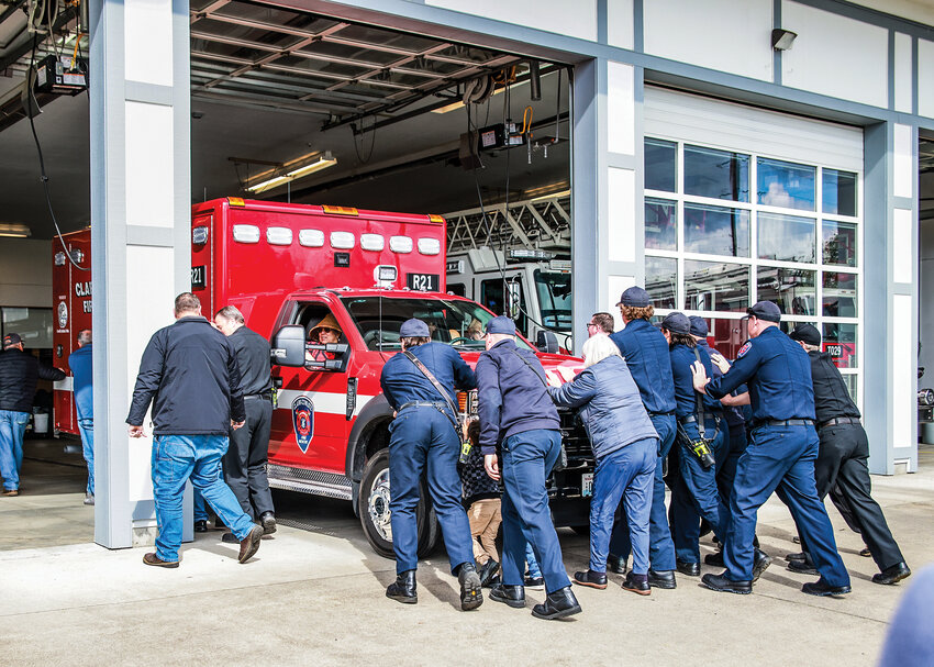Clark-Cowlitz Fire Rescue personnel and community members push in the newest unit to CCFR&rsquo;s Station 21 in Ridgefield on Wednesday, May 1. Rescue 21 will become Medic 21 as part of the EMS contract in January 2025 for CCFR to transport high priority patients.