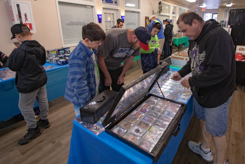 FILE PHOTO &mdash; Vendor Jon McNeely of Chehalis shows cards for sale to potential customers during the Keiper's Cards and Memorabilia Show in downtown Centralia on Sunday, May 5.