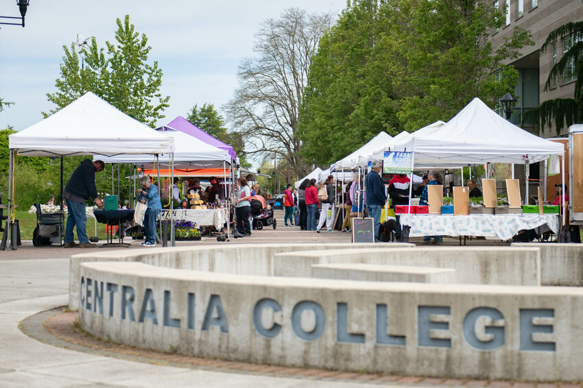 Shoppers browse a selection of vendors at the Centralia Farmers Market at Centralia College on Friday, May 3.