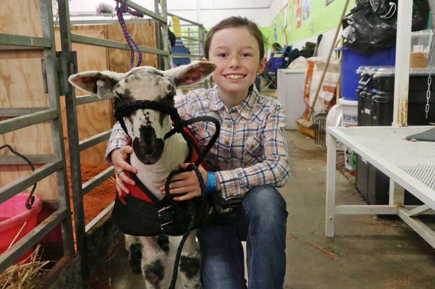 Elena and her sheep, Arthur, stand for a photo at the Southwest Washington Fairgrounds  in Centralia during the Spring Youth Fair on Saturday, May 4.