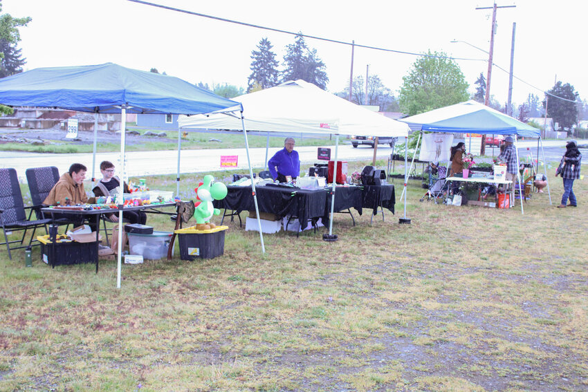 Vendors sit at their tents at the Rainier Saturday Outside Market on May 4.