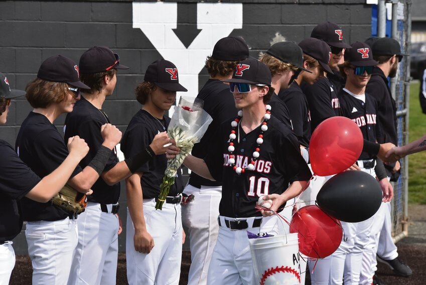 Ace Youckton, surrounded by friends and family, poses for a photo to celebrate Yelm baseball's senior day on May 1.