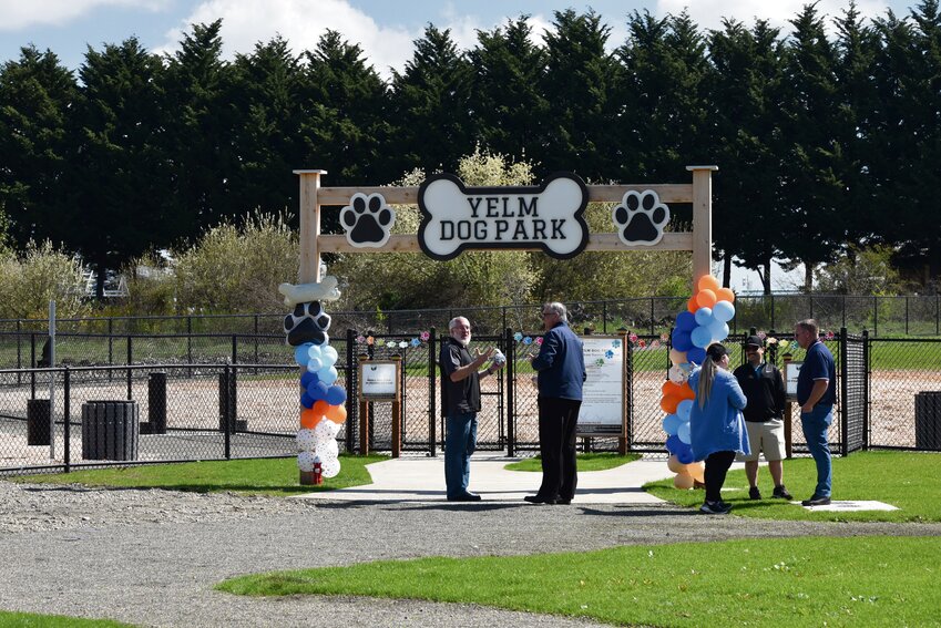 Yelm city officials talk prior to the celebration of the dog park opening.