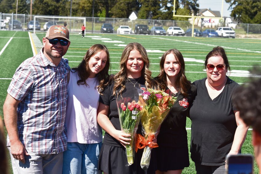 Chloe Corak poses with her family to celebrate Yelm tennis's senior day on May 2.
