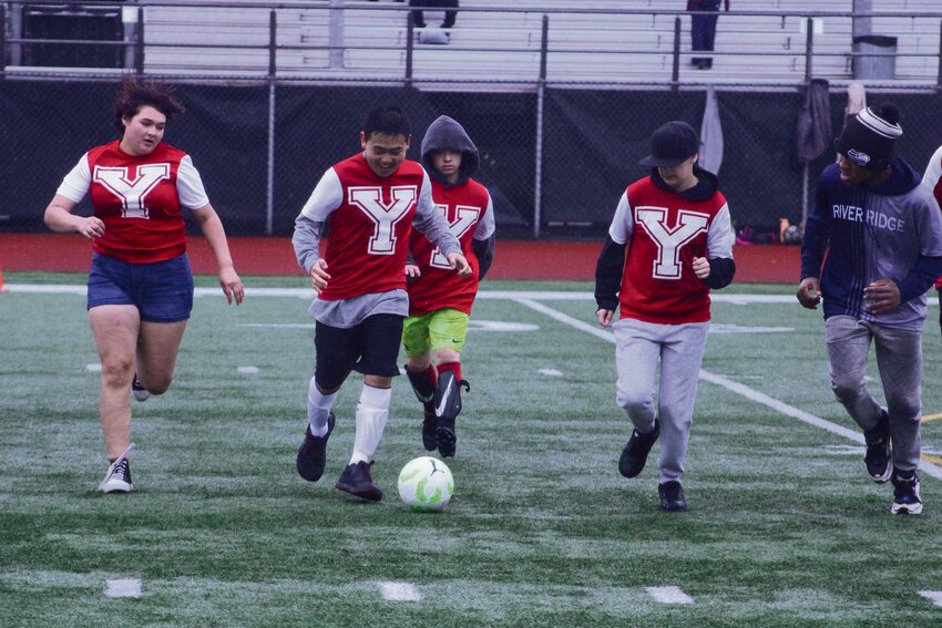 Yelm Unified Soccer huddles in the rain during its final event of the season on May 4 at South Sound Stadium.