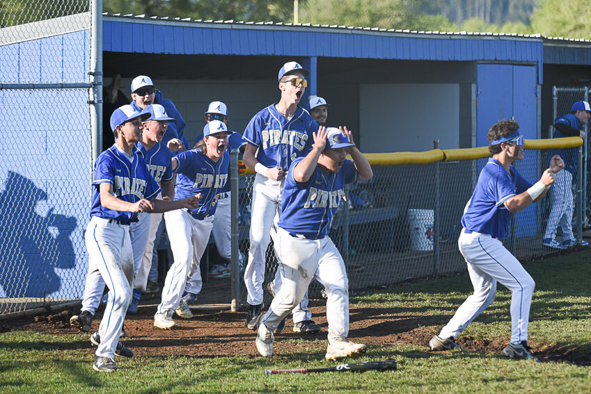 Players spill out of the Adna dugout to celebrate Beau Miller's walk-off single at the end of Adna's 10-9 win over Napavine in the 2B District 4 Semifinals at Adna on May 7.