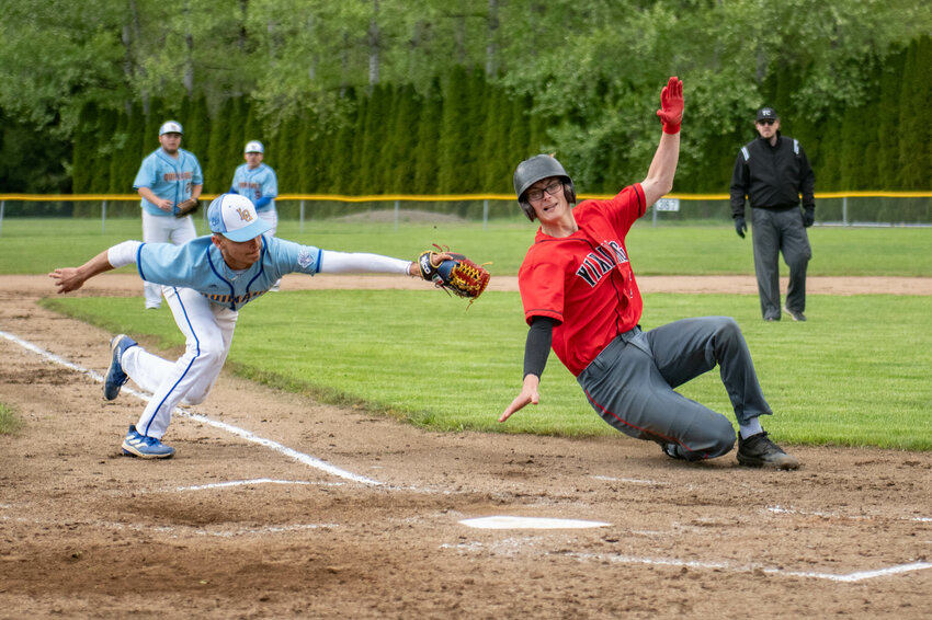 Hunter Isom slides around a tag at home plate during Mossyrock&rsquo;s district tournament win over Lake Quinault on Tuesday, May 7.