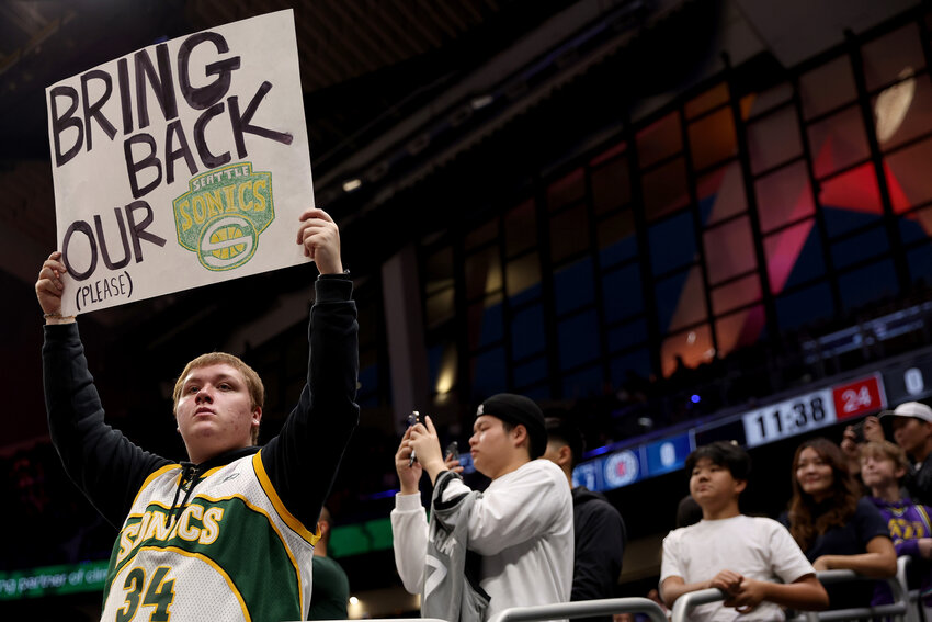 A Seattle Sonics fan holds a sign before the Rain City Showcase in a preseason NBA game between the LA Clippers and the Utah Jazz at Climate Pledge Arena on October 10, 2023 in Seattle, Washington.