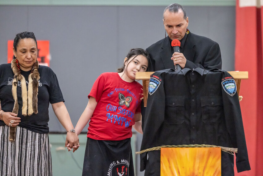 Toledo Police Chief Duane Garvais Lawrence, right, speaks while holding hands with his daughter, Unity Louie Garvais Lawrence and LoVina Louie Lawrence, far left, during the missing or murdered Indigenous persons solidarity event at Toledo Middle School on Sunday, May 5.