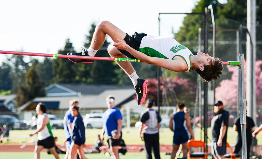 Tumwater's Aaron Paul leaps over the high jump bar during the Evergreen Conference sub-district meet on Wednesday at Tiger Stadium.