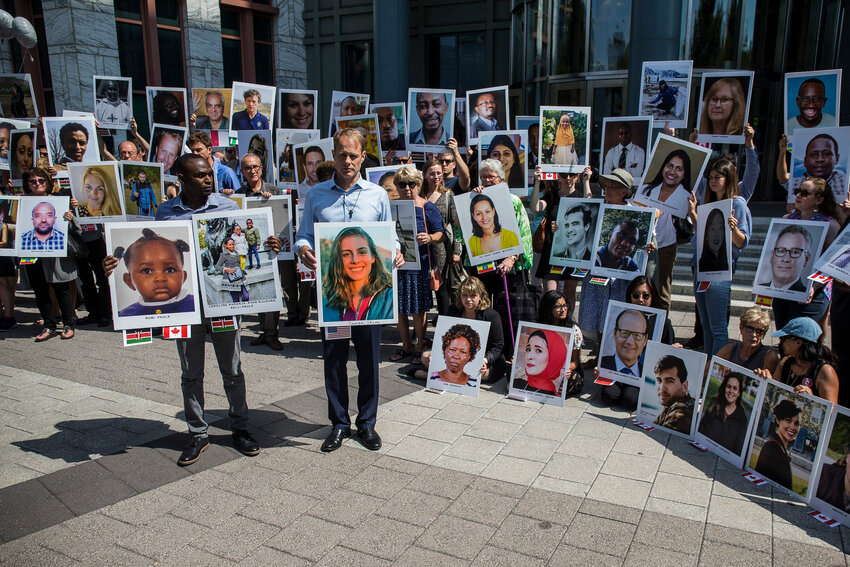 People hold signs during a vigil for victims of the Ethiopian Airlines Flight ET302 crash on September 10, 2019 in Washington, DC. The March 10, 2019 crash killed 157 people.