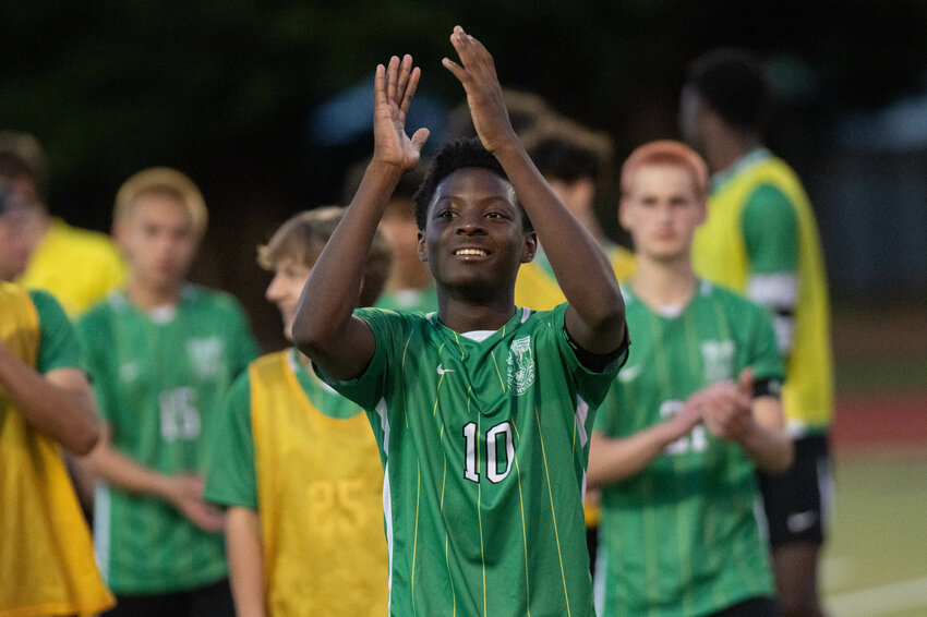 Sam Fagbemi smiles and claps after Tumwater&rsquo;s district elimination game win over Centralia at Tumwater High School on Thursday, May 9.