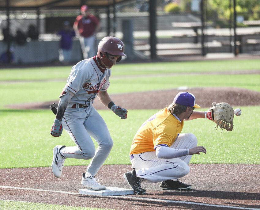 W.F. West's Braden Jones beats the throw to first base against Columbia River during the Class 2A District 4 title game on Saturday at the Ridgefield Outdoor Recreation Complex.