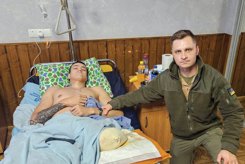 Ukrainian-American Mikhail Pavenko, Vancouver, right, stands next to Yuri, a 19-year-old Ukrainian soldier who had his leg amputated as a result of a mortar, in November 2023. Pavenko has traveled to the front lines of Ukraine as a volunteer chaplain for the last nine years.
