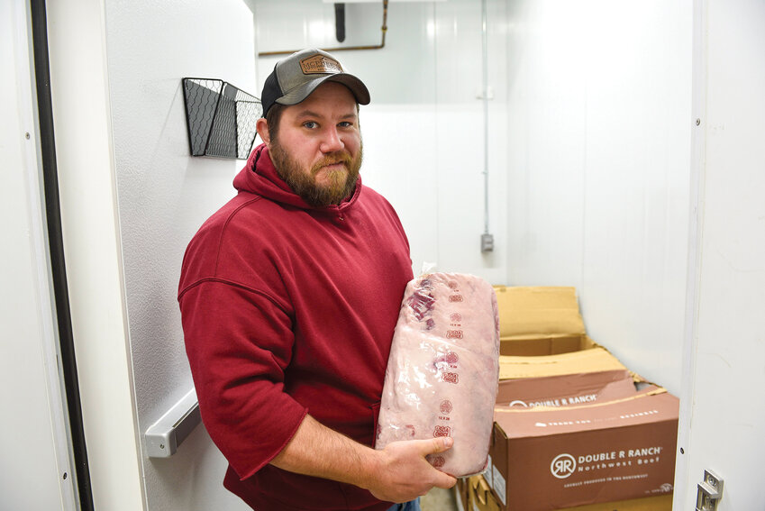 James McPhee holds a ribeye kept at -20 degrees Fahrenheit. He keeps a window in front of the front desk to ensure transparent meat processing.