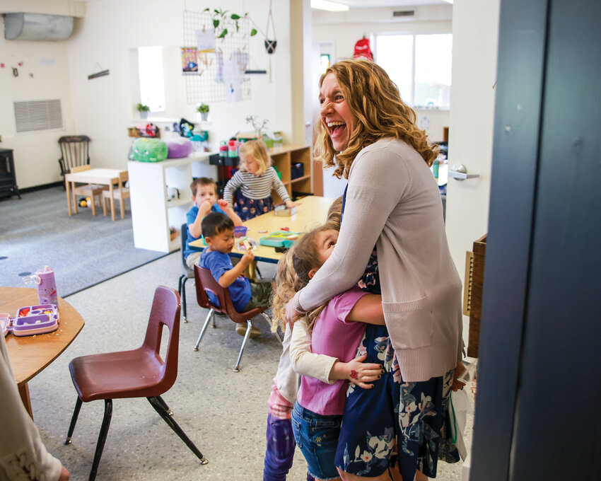 Emily Davis, head of the Gardner School of Arts and Sciences in the Mount Vista area of Clark County, is hugged by students while entering a classroom prior to recess time on Wednesday, May 8.
