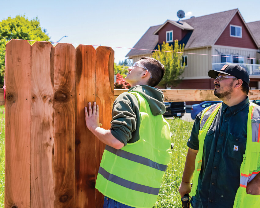 A student from Battle Ground High School learns how to build a fence during a construction trades event at Bridge City Contracting on Wednesday, May 8.