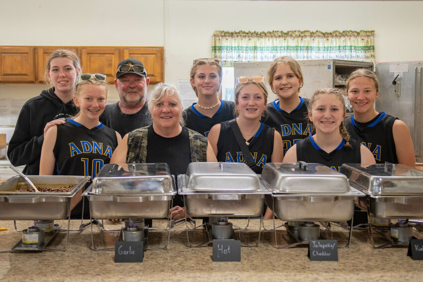 Festival organizers Jim and Cindy Smith smile for a photo with members of the Adna girls basketball team during the first Adna Sausage Festival, held at the Adna Grange on Saturday, May 11. The festival was hosted by Adna Grocery and Uncle Jim&rsquo;s Smokehouse. All proceeds will go toward the Adna girls basketball program. Jim and Cindy Smith, owners of the businesses, previously presented members of the Adna High School football program with a check for $5,342.63 after hosting the Adna Crab Feed fundraiser in April.