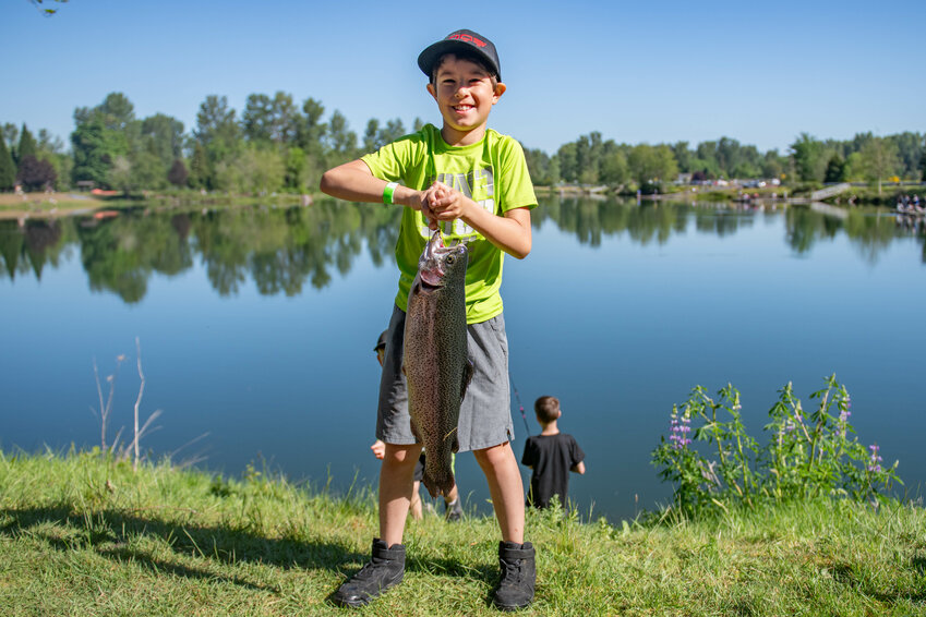 Tuff Husser, 8, holds up the 5.4-pound trout he caught Saturday, May 11, at the Toledo Lions Club&rsquo;s annual Jim &amp; Penny Lancaster Kids Fishing Derby at South Lewis County Park Pond &mdash; also known as Wallace Pond &mdash; in Toledo. All proceeds from the derby go toward Toledo Lions Club scholarships, which are provided to youths in the community.