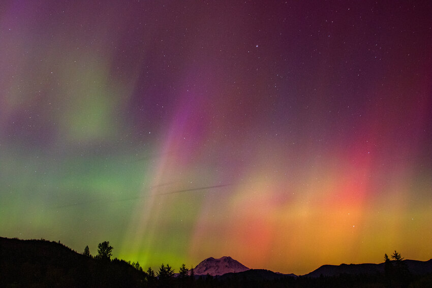 Mount Rainier glows in the distance under the Northern Lights, which were visible as far south as Florida during a powerful geomagnetic storm that hit the earth on Friday, May 10.