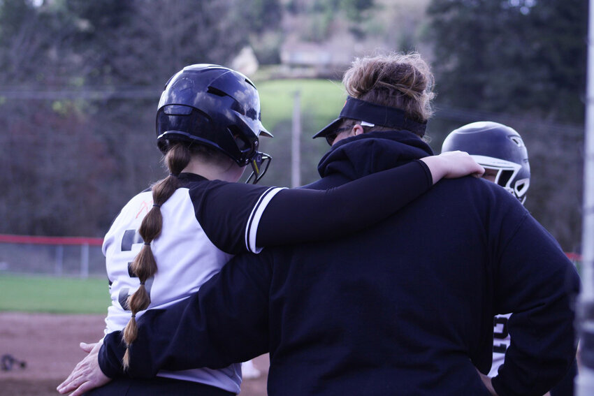 Brooklynn Swenson and Katie Qualls embrace during a contest against Tenino on March 26.