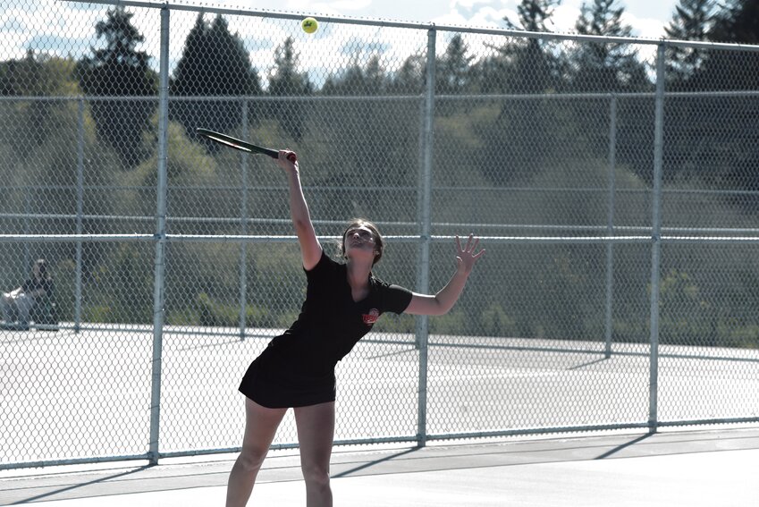 A Yelm tennis athlete swings the racket during competition against River Ridge on May 2.