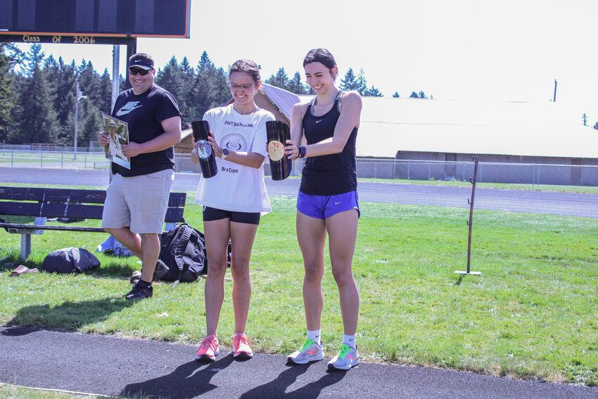 Ella Marvin and Acacia Murphy celebrate setting school records by breaking records on May 14.