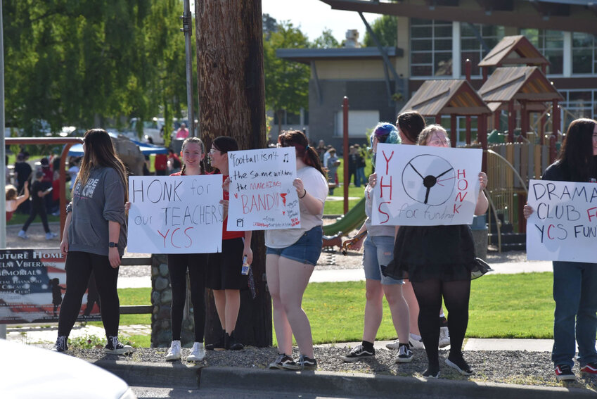 YCS students stand on the corner of First Street and Mosman Avenue and display signs protesting the recent levy failures, Wednesday, May 15.