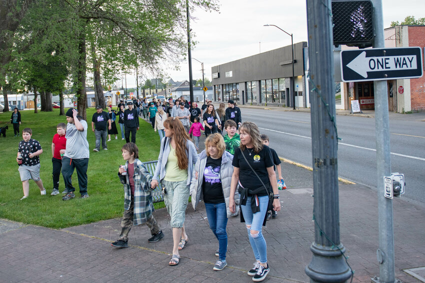 Walkers turn the corner of West Main Street and South Pearl Street during the 2024 Walk for Recovery on Monday, May 13, in Centralia.