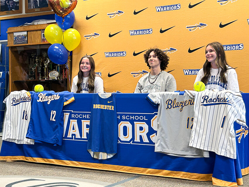 From left to right, Rochester's Macey Fluetsch, Parker McAferty, and Sara Haury smile for a photo at a signing day event in the Rochester High School foyer on May 15.