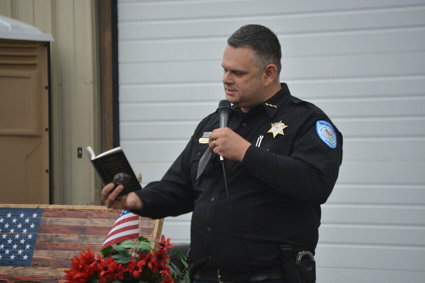 Former Morton Police Chief Roger Morningstar reads from a book of quotes from the founding fathers during a freedom rally event in September 2020.