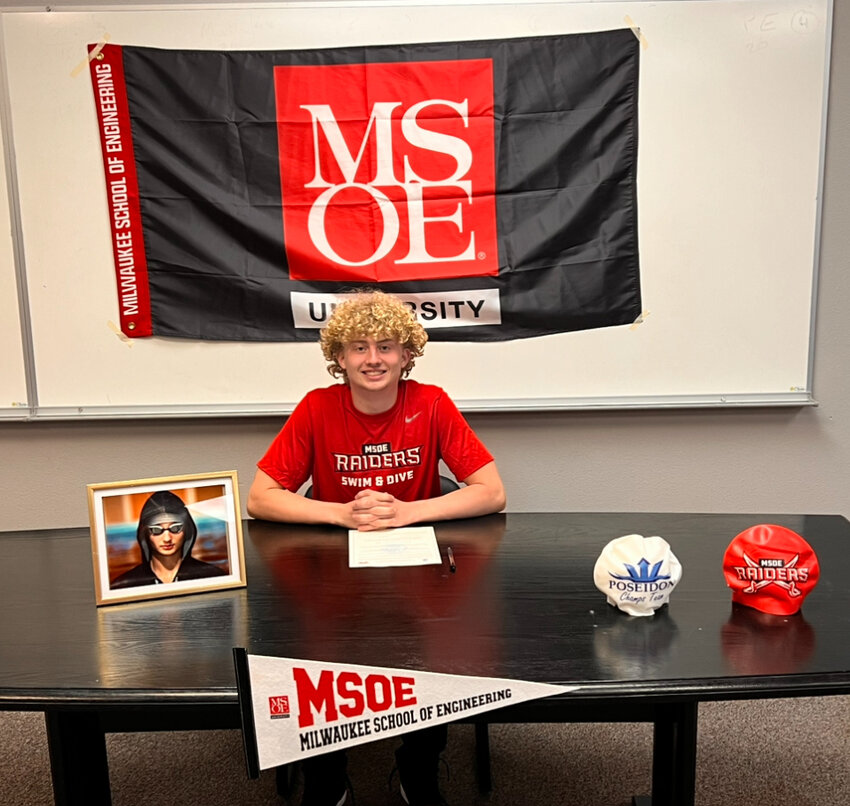 W.F. West High School senior Cayden Page poses for a photo with Milwaukee School of Engineering gear. Page has signed a letter of intent to compete for the Raiders&rsquo; swim and dive team in Kenosha, Wisconsin, while pursuing a B.S. in mechanical engineering, a master&rsquo;s in nuclear engineering, and a Ph.D. in mathematics.