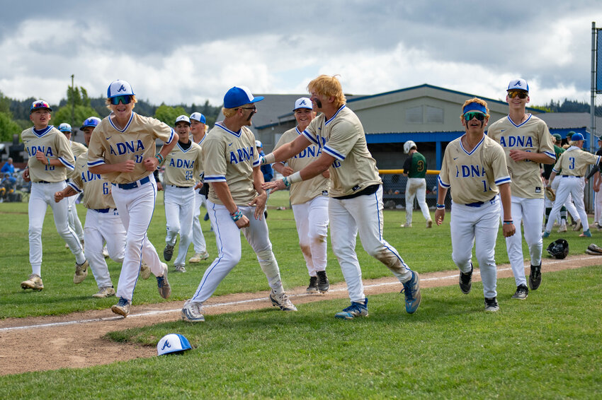 Pirate players celebrate after defeating Northwest Christian to secure a spot in the 2B Baseball State Final Four at Adna High School on Saturday, May 18.