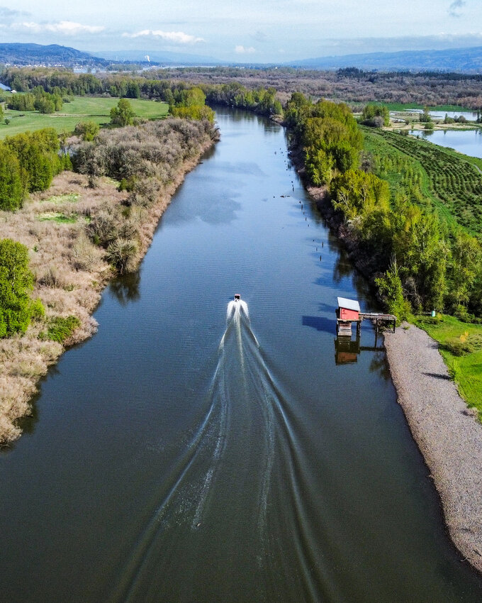 A boat heads north on the Lake River in Ridgefield toward the Columbia River in April.