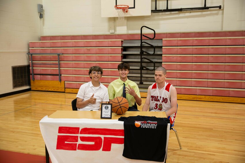 Student broadcasters Rayder Stemkoski, left, and Kaven Winters, center, prepare to interview Toledo High School Student Chris Harvey following his 4,000th career half-court shot on Monday, May 20.