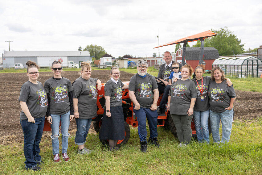 From left, Centralia Salvation Army volunteers and staff members Sasha Bostwick, Jill Wilber, Tacy Pendleton, Gin Pack, Brian Winger, Steven Pack, Jacob Pack, Jennifer Smith, Danita Madrano and Leslie Cadmanat pose for a photo at Harvesting Hope Farm at Salvation Army in Centralia on Friday, May 17.