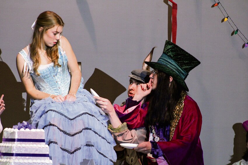 Cora Hobbs (Alice), William Sargent (Mad Hatter) and Thomas Linford (March Hare) rehearse a scene for &quot;Alice in Wonderland&quot; at Yelm High School on May 16.
