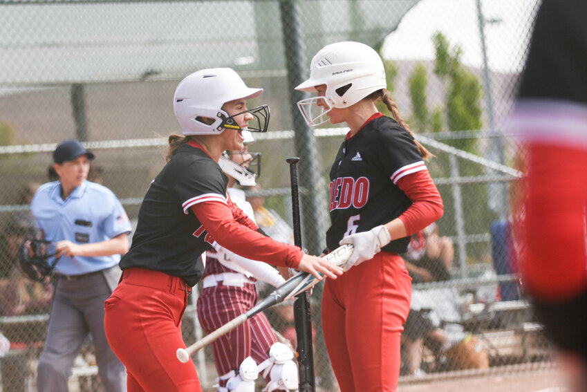 Toledo's Quyn Norberg (left) celebrates with Zaya Norberg after scoring a run during Toledo's opening round matchup against Ocosta at the Gateway Sports Complex in Yakima on May 24.