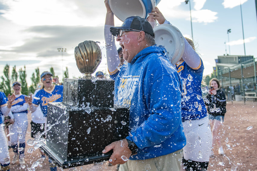 Pirate head coach Bruce Pocklington is showered with ice water from his players after Adna&rsquo;s 2B State Softball championship win over Warden at Gateway Sports Complex in Yakima on Saturday, May 25.