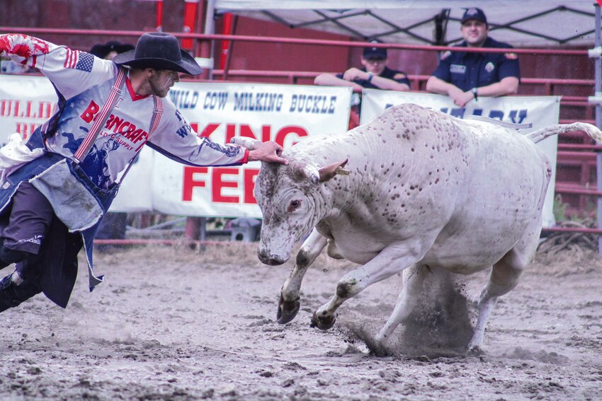 A bullfighter staves off an angry bull after it threw off its rider during the Roy Rodeo on June 1.