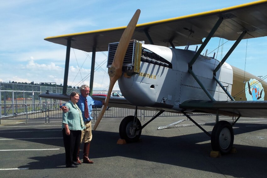 Robert &quot;Bob&quot; Dempster and his wife, Diane, pose next to the Seattle II, a Douglas World Cruiser reproduction aircraft the couple spent more than 15 years building along with other mechanics and historians.