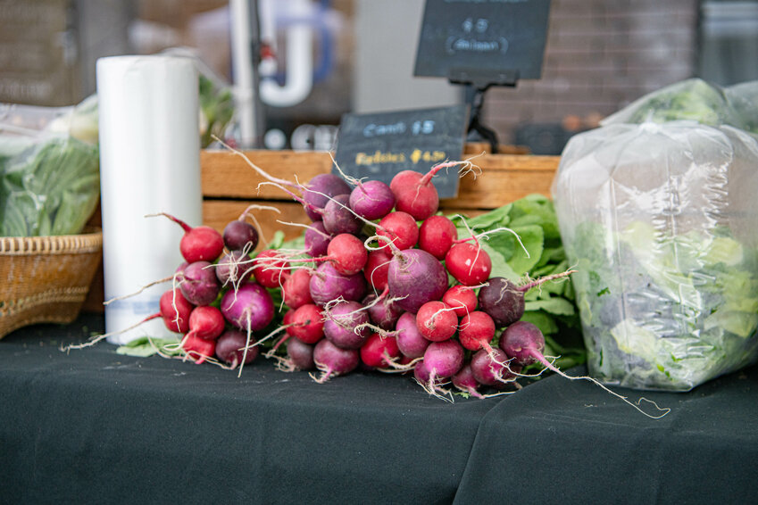 Radishes for sale are put on display at the Community Farmers Market of Chehalis in downtown Chehalis on Tuesday, June 4.