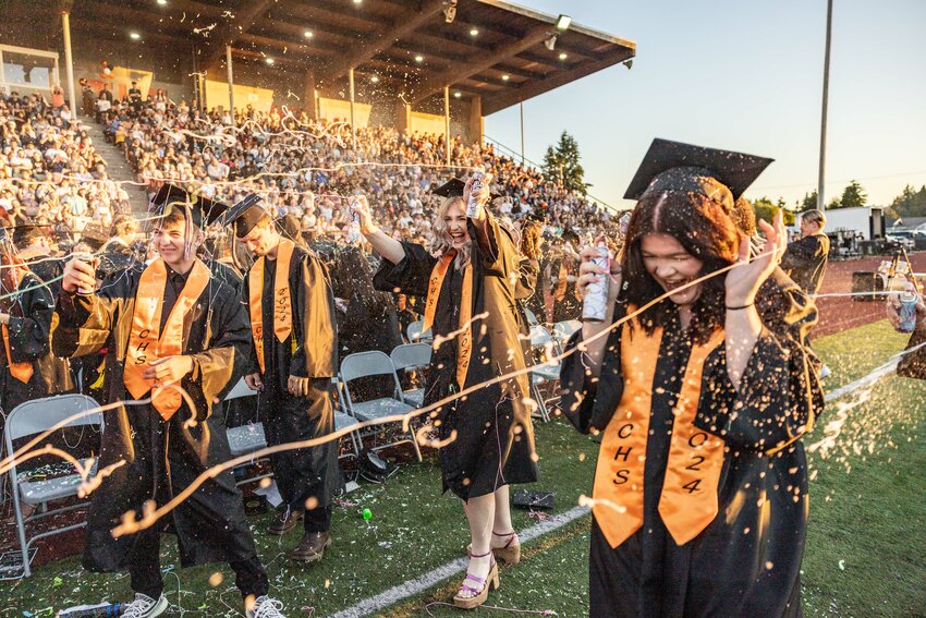 Centralia High School graduates spray Goofy Spray at Tiger Stadium to end the commencement ceremony on Friday, June 7.