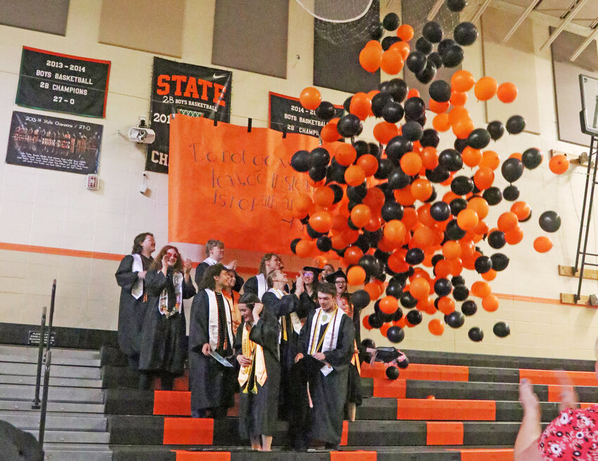 The White Pass High School class of 2024 gets balloons dumped on them at the end of a commencement ceremony in Randle on Saturday, June 8.