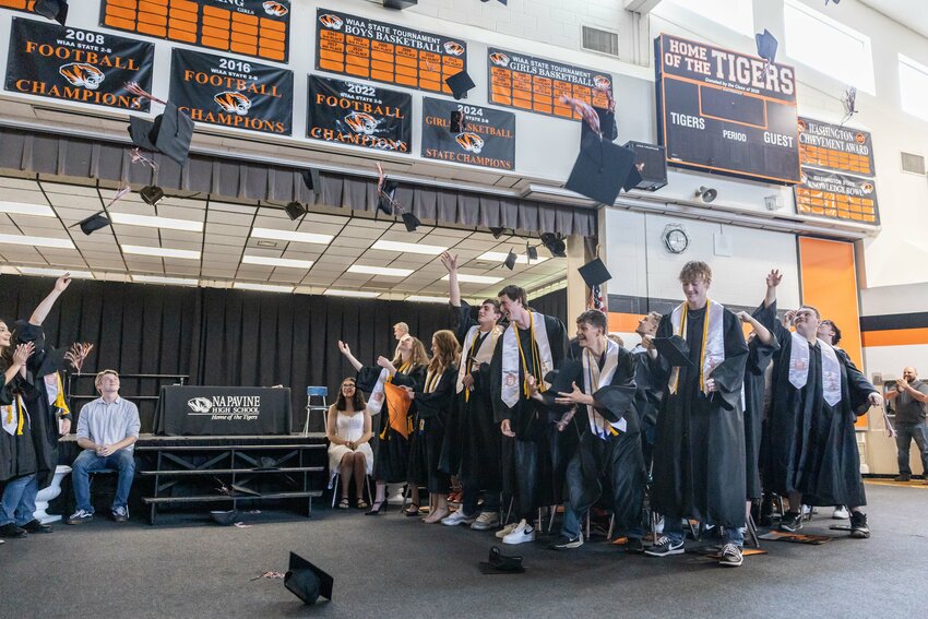 Graduates throw their caps during the Napavine High School graduation ceremony on Saturday, June 8.