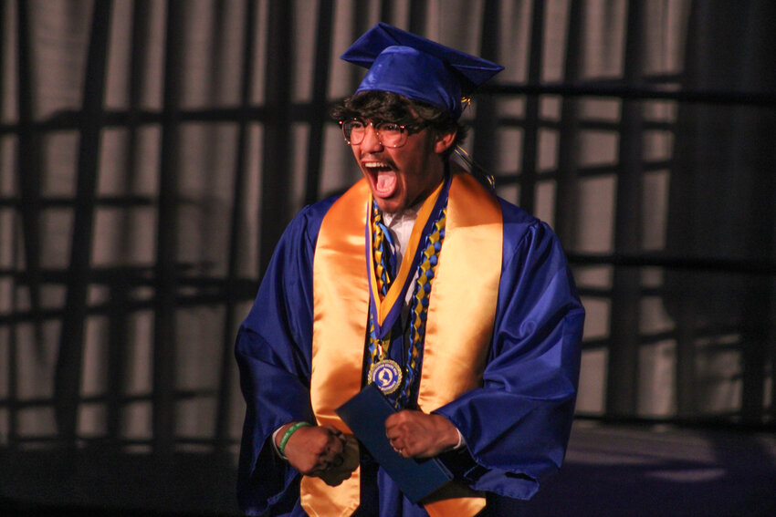 A graduate lets out a celebratory yell toward his family during Rochester High School's Class of 2024 graduation at Marcus Pavilion at Saint Martin's University on Sunday, June 9.