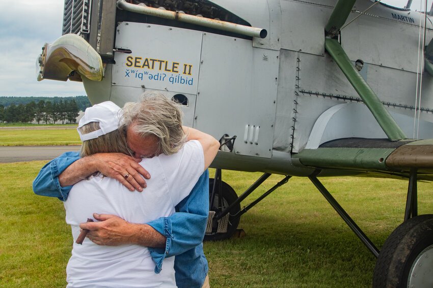 Robert &quot;Bob&quot; Dempster hugs his wife, Diane, on Saturday, June 8, after firing up the engine of the Seattle II for the final time at the Chehalis-Centralia Airport.