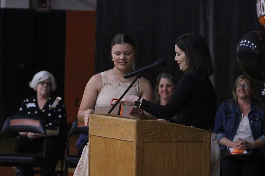 Rainier High School Assistant Principal Kristin Robinson, right, awards Raychel Hansen, left, with the Citizenship Award during Rainier High School's senior awards night on June 4.